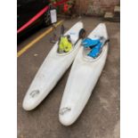 Two Kayaks together with a pair of ores and two life jackets