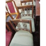 A set of four ash spindle back dining chairs and two occasional chairs, all with green upholstered