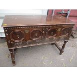 A late 17th/early 18th century oak carved side cabinet having two inset drawers and beaded