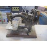 A late 19th century Willcox & Gibbs sewing machine on an oak base
