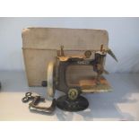 A miniature Singer sewing machine, marked The Singer Manfg.co