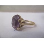 A yellow gold single stone ring, claw set with an oval amethyst, 4.3g