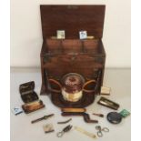 A Victorian oak smokers cabinet having metal mounts and revolving interior containing a Doulton