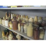 A collection of stoneware bottles and jars, some advertising examples to include R. Whites Ginger