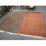 Two Turkish rugs to include a red ground elephant foot motif rug, 190 x 127cm and a floral rug