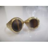 Two 9ct gold gents rings each set with tigers eye, 8.8g