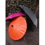 A Giorgio Armani branded umbrella and another by Charles Jourdan, together with a burnt orange