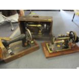 Three vintage Singer and Defiance sewing machines comprising model and serials Singer ED002125 dated