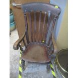 A 19th century stained elm seated lathe back Windsor armchair