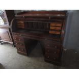 A Victorian mahogany roll top desk having a slide out fitted interior supported by twin pedestals