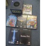 A Nintendo GameCube console together with mixed games to include The Sims, Star Wars and others
