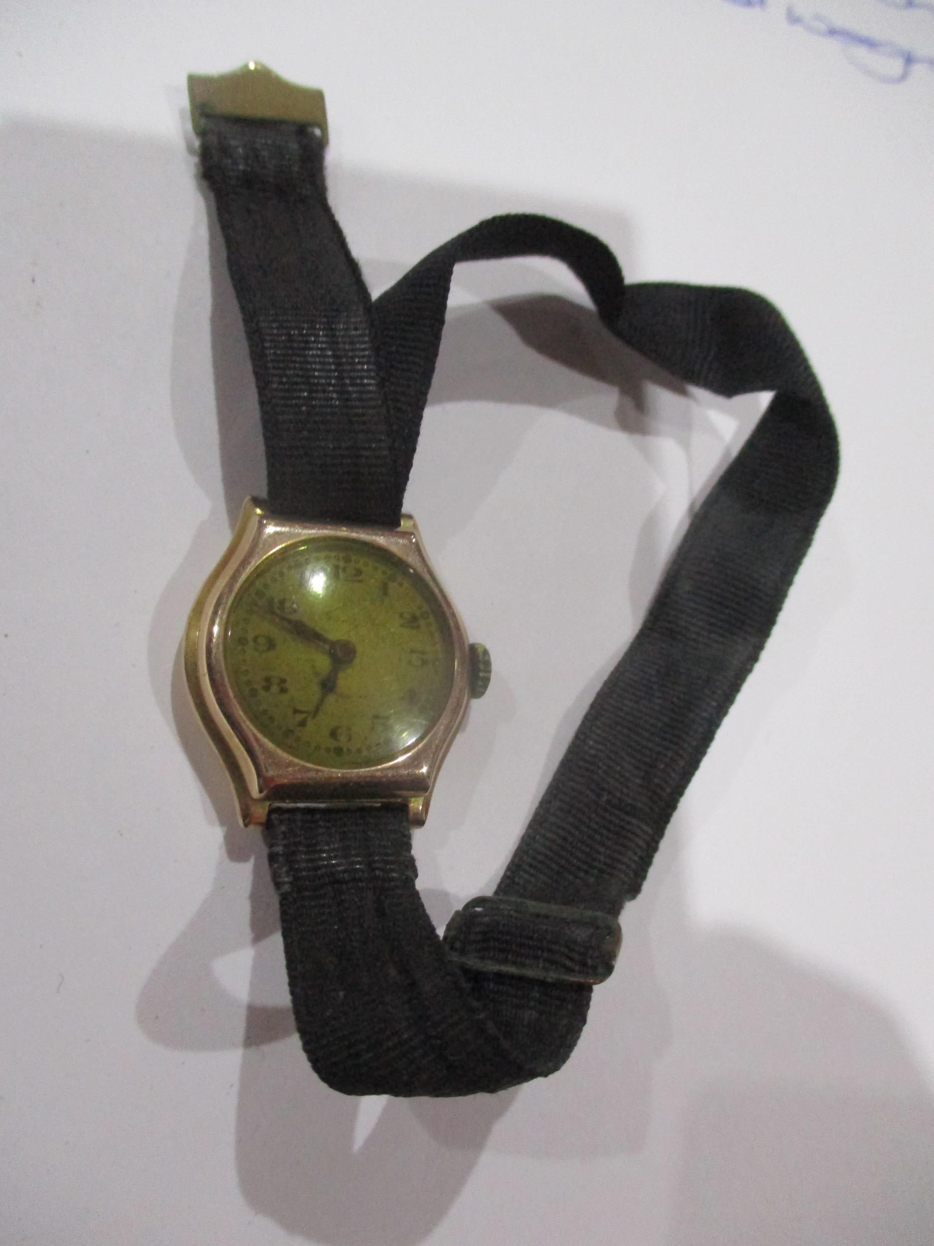 A ladies gold cased wristwatch, 9ct with ribbon bracelet, total weight 11.35g Location: CAB