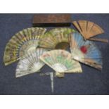Six early 20th century fans with mother of pearl, ivory or treen wands together with mother of pearl