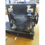 A 1950s Singer 221k electric sewing machine, serial number EL213218, with foot pedal, manuals and