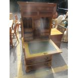 A reproduction yew wood cabinet/writing desk having a fall flap revealing fitted interior and a