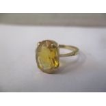 A 9ct yellow gold ring, claw set with an oval citrine