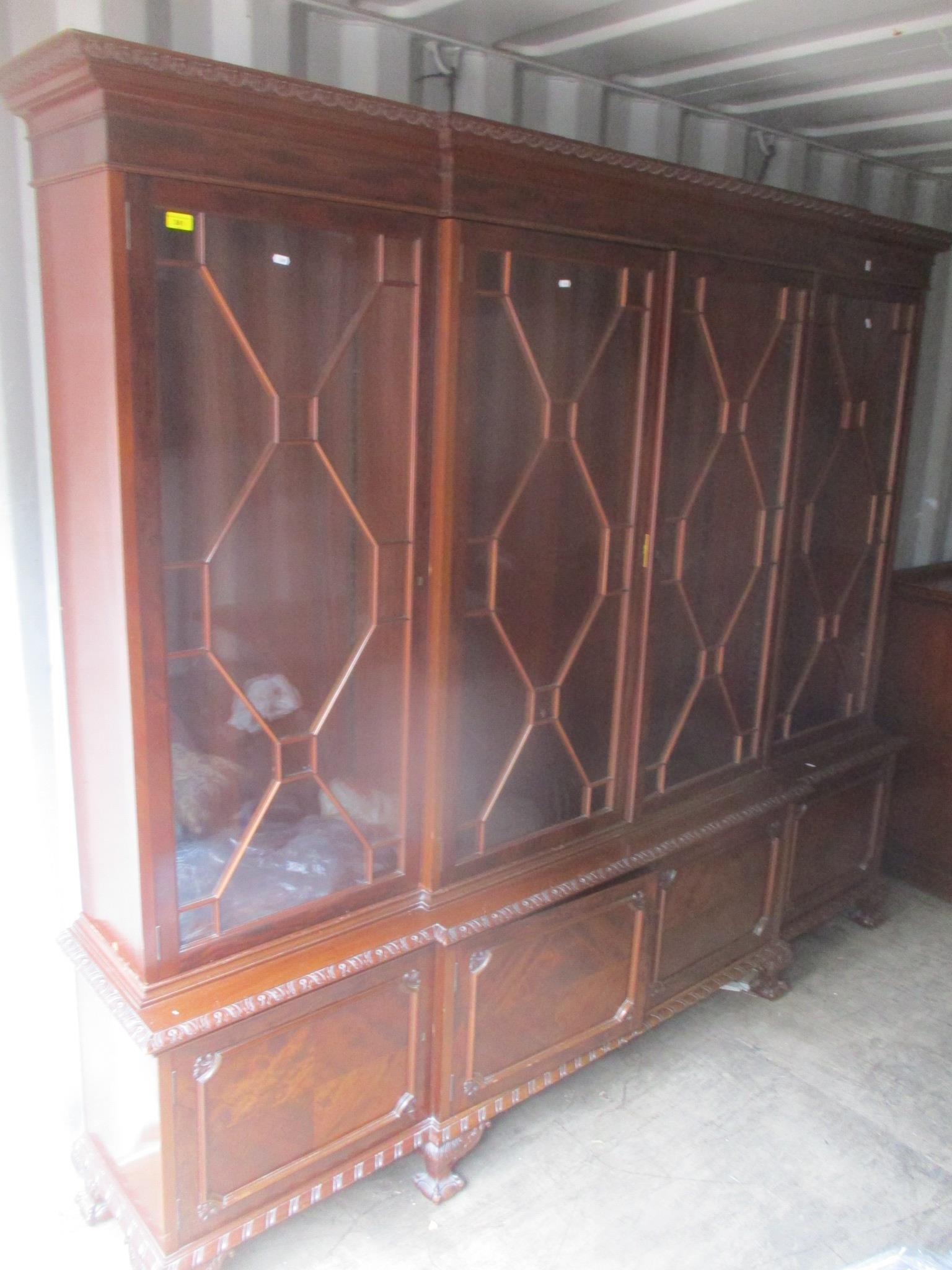 A large 1920's mahogany display cabinet/bookcase having four astragal glazed doors with four