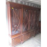 A large 1920's mahogany display cabinet/bookcase having four astragal glazed doors with four