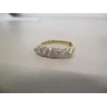 An 18ct gold and platinum ring set with five diamond, the centre stone chipped, 4g