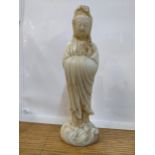 A Chinese off white jade coloured statue of a woman on a wave design base 24cm high