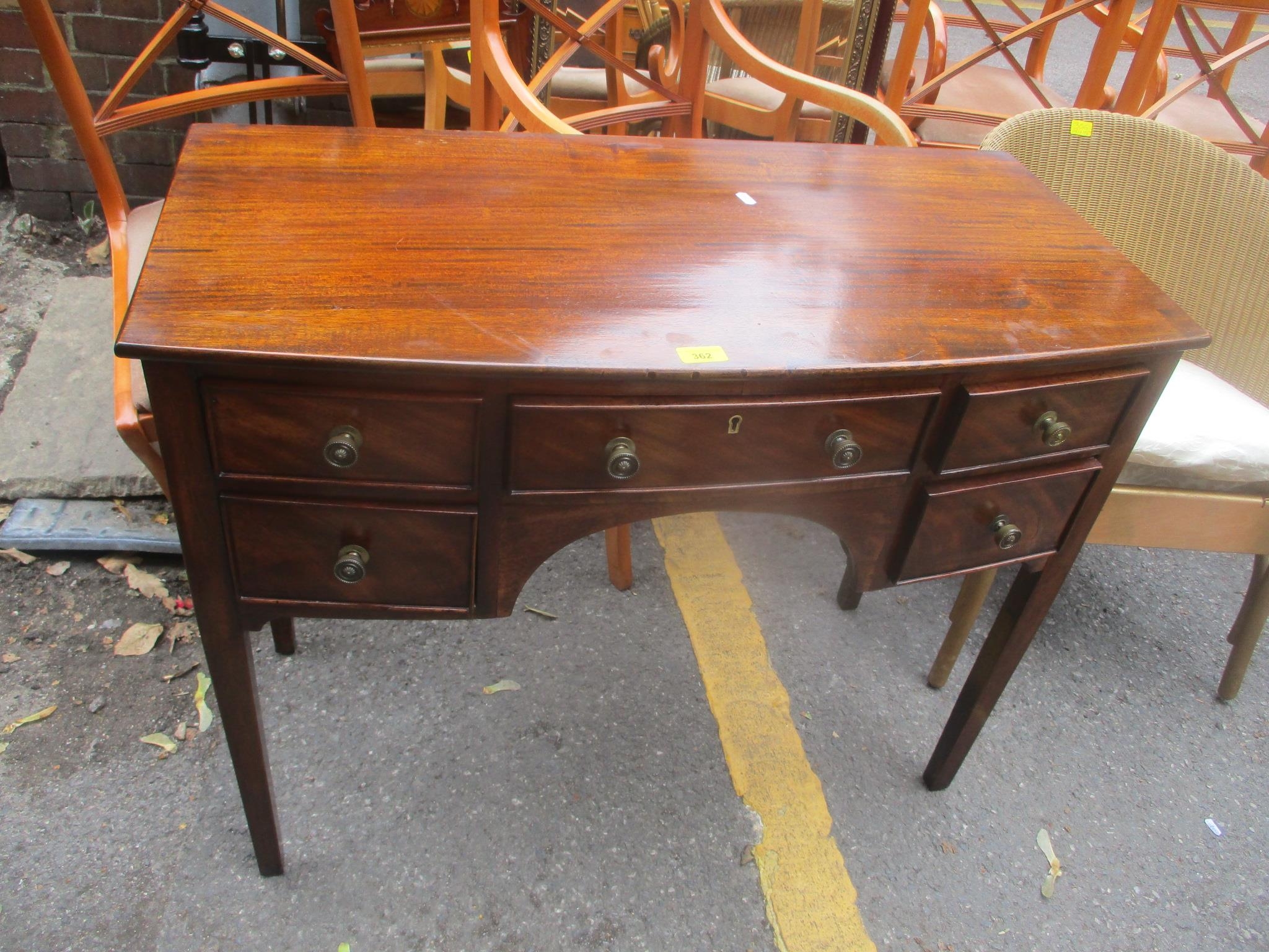 A 19th century mahogany kneehole desk having five drawers and tapered squared legs, 74.5 h x 93cm w