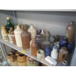 A collection of mainly stoneware bottles and jars, some advertising examples to include Thompson