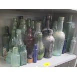 A selection of 19th century and later glass bottles to include advertising examples for Barretts