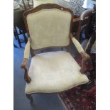 A reproduction French style beech framed armchair on cabriole legs