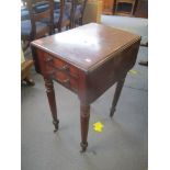 A Victorian mahogany work table having two fall flaps, two inset drawers and on tapered turned