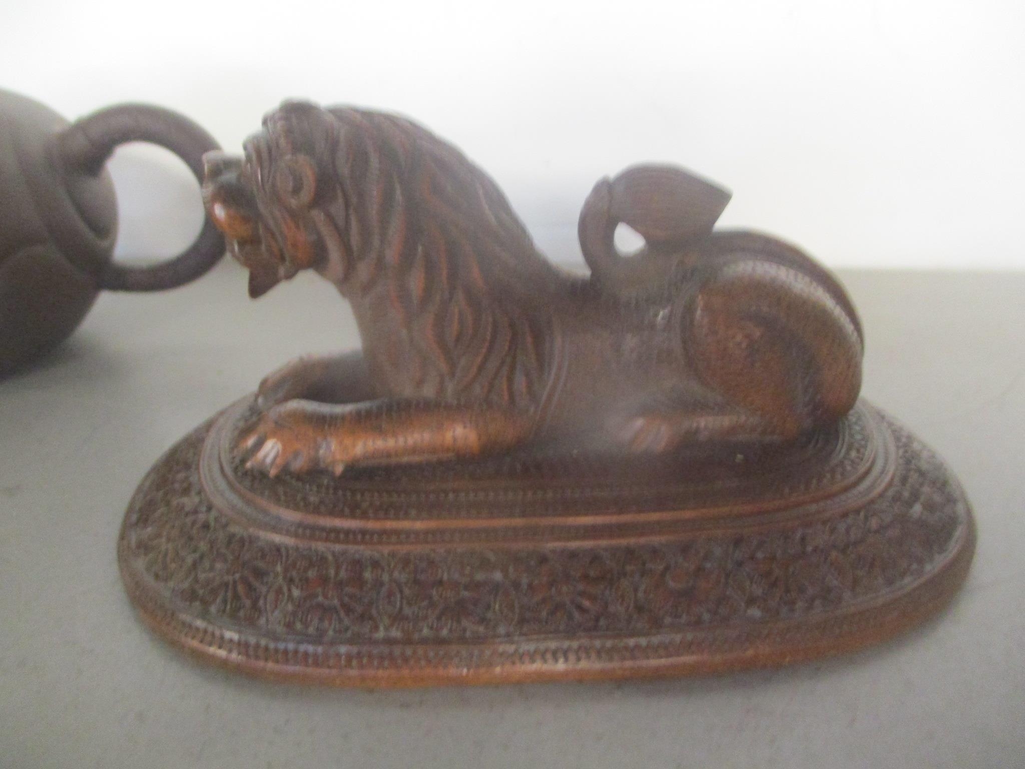 A 20th century Chinese Yixing Zisha pottery teapot and an Indian carved wooden model lion on a - Image 3 of 3