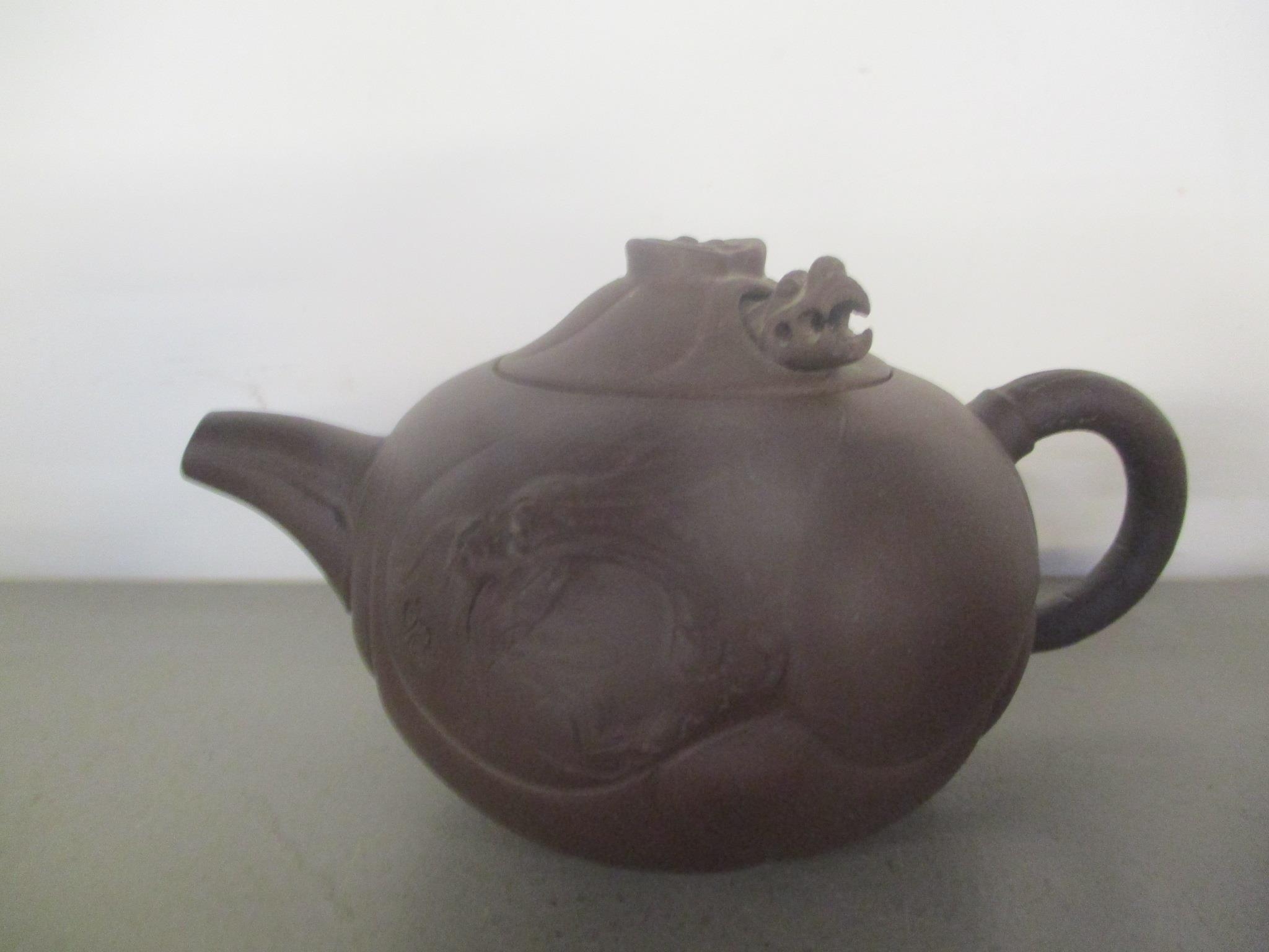 A 20th century Chinese Yixing Zisha pottery teapot and an Indian carved wooden model lion on a - Image 2 of 3