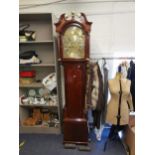 A George III mahogany long case clock, circa 1820, with broken swan neck pediment, arched brass dial