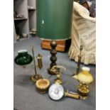 Lamps to include a turned oak and brass, three brass, a Lucas head light and a ceramic and brass