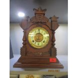 An Ansonia Clock Co mantel clock, carved American walnut case, with gilt dial and cream enamelled