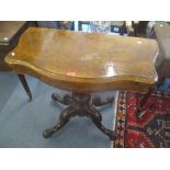 An early 20th century walnut fold over card table standing on four carved scroll legs 74.5cm h x