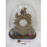A late 19th century gilt spelter mantel clock, surmounted by a woman under a glass dome