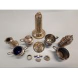 Silver to include a miniature trophy cup, pepper pot, mustard pots, and three brooches 199g, and a