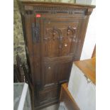 An 18th century oak cabinet with a three quarter high panelled door on a plinth, 182cm high x 87cm