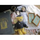 A retro woollen shawl in white, two Guernsey collectors dolls with porcelain faces, a Deans Rag Book