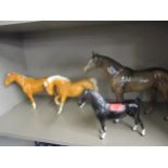 Four Beswick models of horses to include a palomino Condition: the ear of the largest horse has been