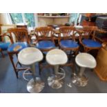 An early 20th century oak Ee-Zi-Way extending table together with four Bentwood high stools and