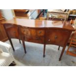 A Georgian style mahogany serpentine front sideboard, with label for Edwardes, 93 h x 151 w x 56cm d