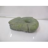 A carved green jade coloured decorated with a head