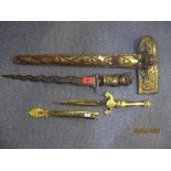 An Indonesian 20th century giltwood and carved handled Kris with sheath, a Spanish gilt metal dagger