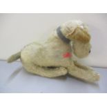 A vintage blonde faux fur dog soft toy with leather collar, straw filled having glass eyes and a