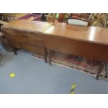 A George III drop leaf dining table in mahogany together with a Victorian mahogany Sutherland table,