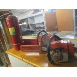 A Stihl chainsaw, together with an Husqvarna chainsaw, and a vintage Minimax fire extinguisher