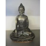 An early to mid 20th Century white metal Vajrasana Buddha, height cm, on a wrapped copper base.