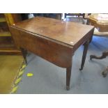 An early 19th century mahogany Pembroke table having an inset drawer and on fluted legs 71cm h x