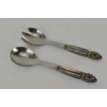 A pair of Georg Jensen salad servers with silver handles and stainless steel blades Condition: